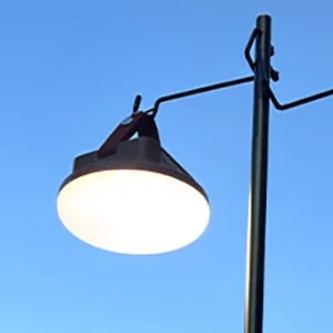 青空を背景に、明るく点灯している屋外の街灯が写っています。シンプルながらも、光と空のコントラストが印象的な一枚です。