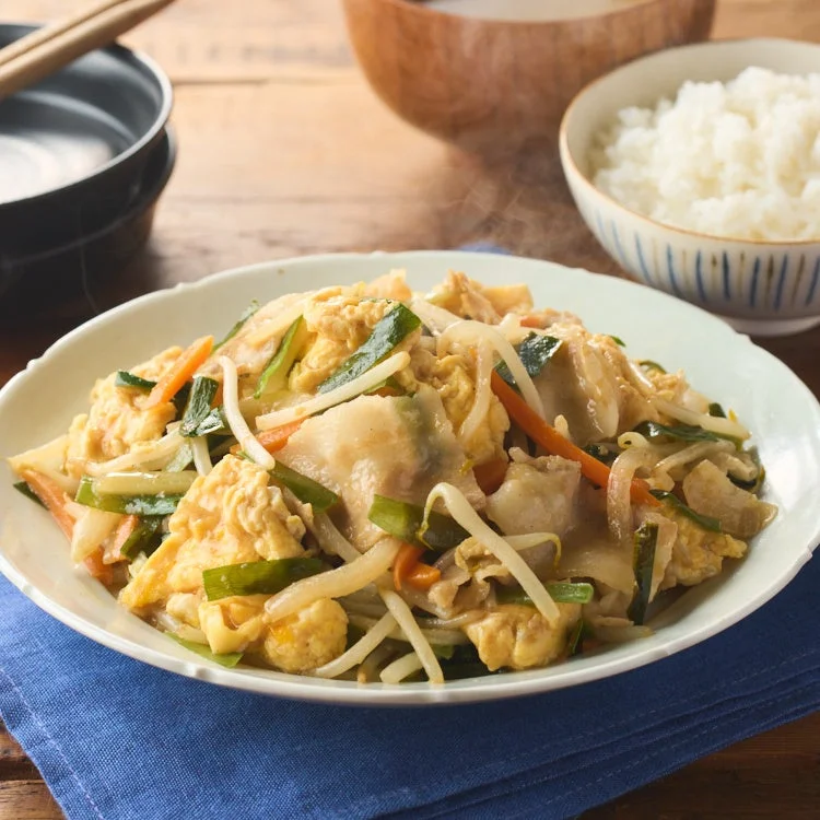 温かい湯気が立つ豚肉と卵、野菜の炒め物がメインの和食定食