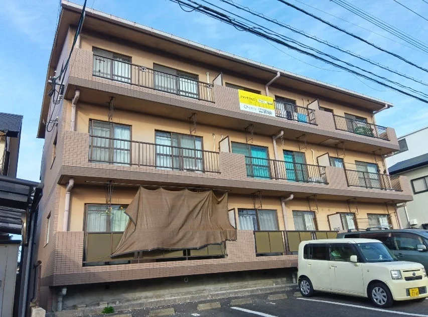 青空の下、3階建てのアパート